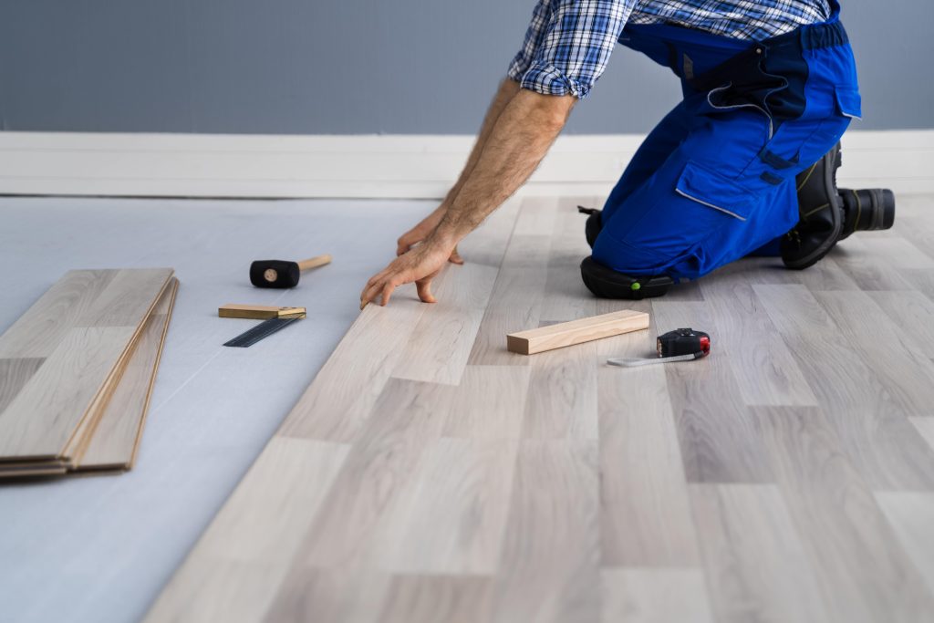 home improvement worker laying floor boards