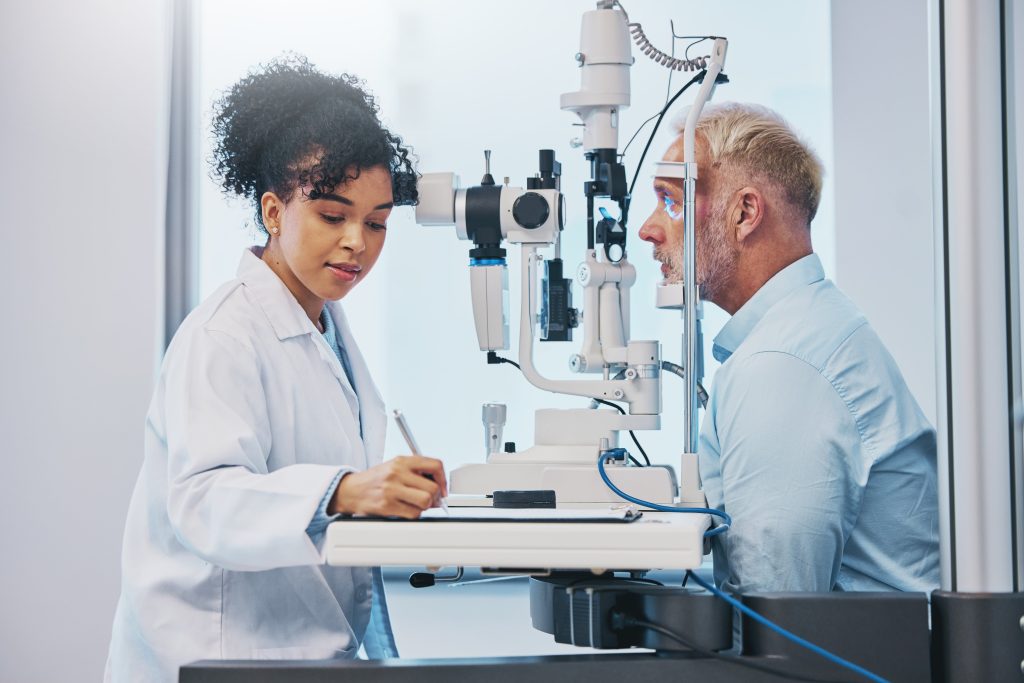 female optometrist examining male patient