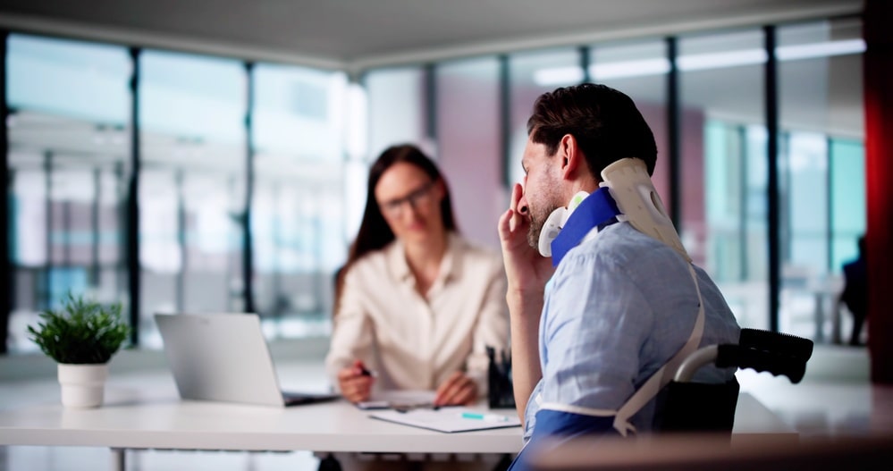 personal injury lawyer consulting with injured patient