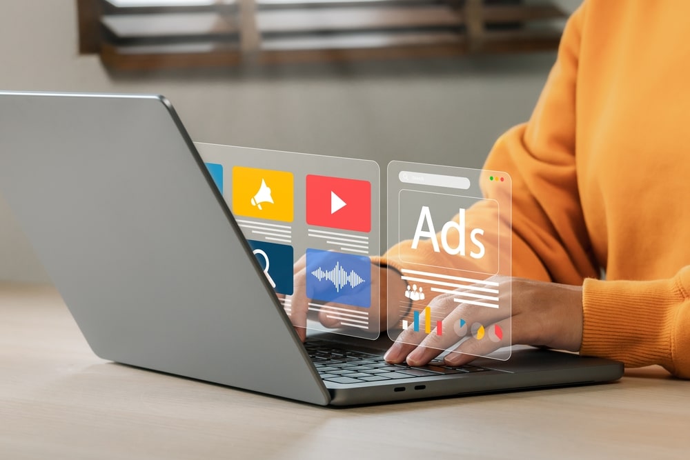 Person viewing Google Ads and YouTube campaign dashboard for PPC advertising strategy.