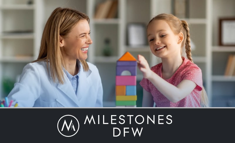 A therapist laughing with a young girl playing with building block. Milestones DFW logo at the bottom with a black background.