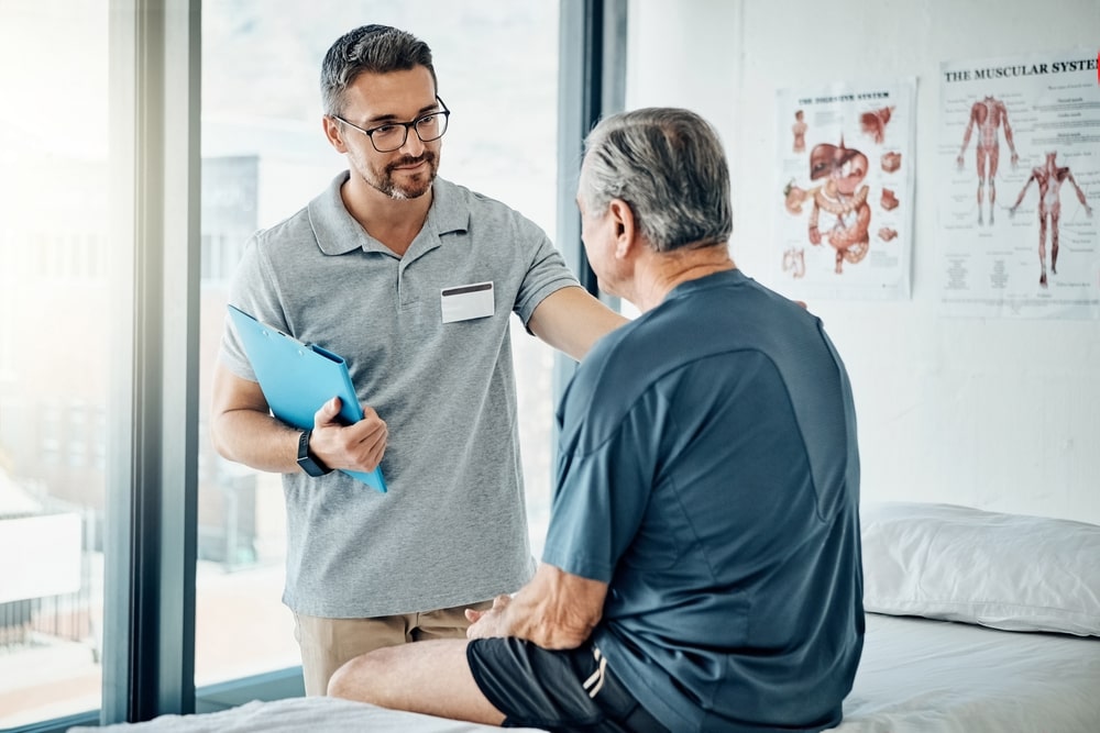 chiropractor consulting with patient