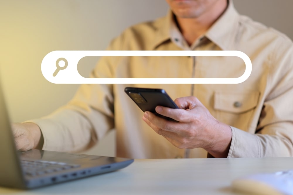 person typing into search bar with question