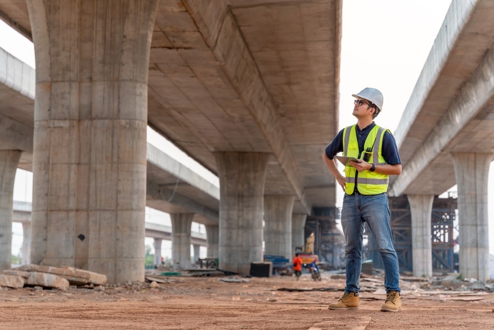 construction worker looking over infrastructure improvements to city highways