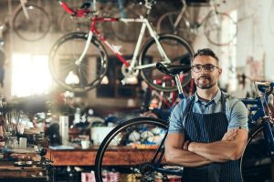 man posing in his bike shop